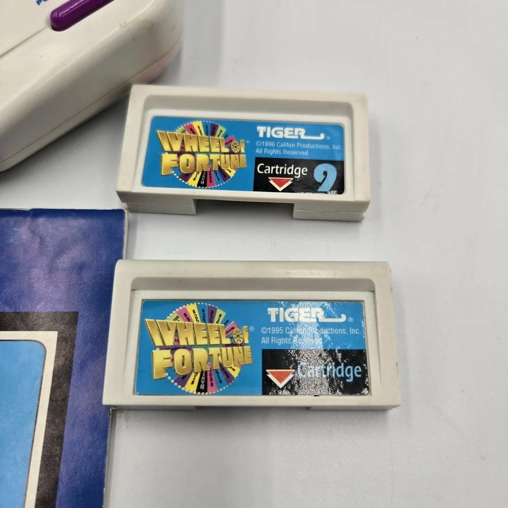 1995 Tiger Hand Held Electronic Wheel Of Fortune Expansion Cartridges Book & VHS